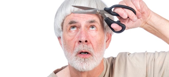 hombre mayor cortando su propio flequillo