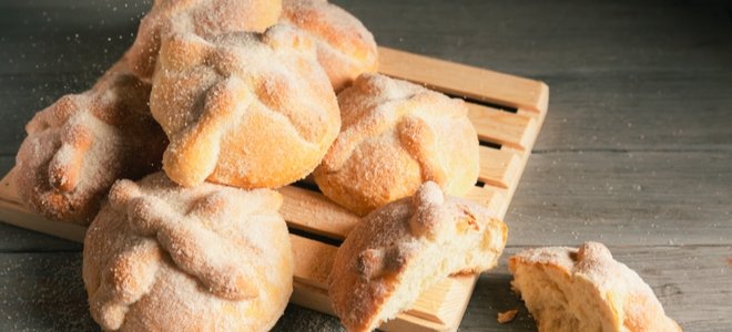 hogazas redondas de pan del Día de Muertos con diseños de cruces en la parte superior