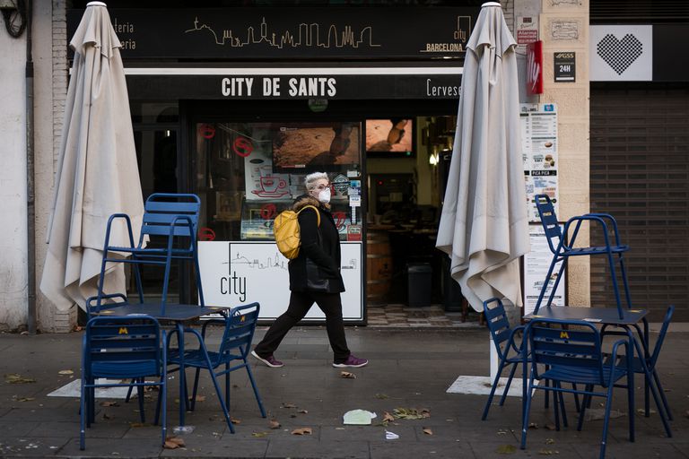 Una mujer pasa por delante de una terraza vacía de un bar de Barcelona, el 24 de enero.