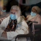 Residents look at the street through a window at the Icaria nursing home in Barcelona, Spain, Nov. 25, 2020. The image was part of a series by Associated Press photographer Emilio Morenatti that won the 2021 Pulitzer Prize for feature photography. (AP Photo/Emilio Morenatti)