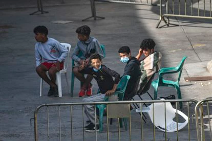 Algunos de los menores acogidos en una de las naves del polígono del Tarajal, en Ceuta, el pasado 24 de junio.