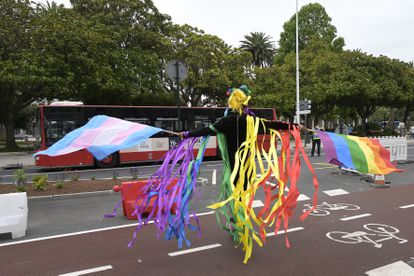 Una persona ondea las banderas LGTBI y 'trans' durante la manifestación convocada por el Día Internacional del Orgullo LGTBI en A Coruña.