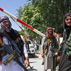 Taliban fighters stand guard along a roadside near the Zanbaq Square in Kabul on August 16, 2021, after a stunningly swift end to Afghanistan's 20-year war, as thousands of people mobbed the city's airport trying to flee the group's feared hardline brand of Islamist rule. (Photo by Wakil Kohsar / AFP)