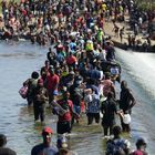 Haitian migrants use a dam to cross to and from the United States from Mexico, Friday, Sept. 17, 2021, in Del Rio, Texas. Thousands of Haitian migrants have assembled under and around a bridge in Del Rio presenting the Biden administration with a fresh and immediate challenge as it tries to manage large numbers of asylum-seekers who have been reaching U.S. soil. (AP Photo/Eric Gay)
