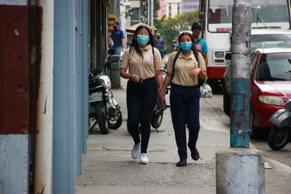 Dos estudiantes caminan por las calles de Caracas.