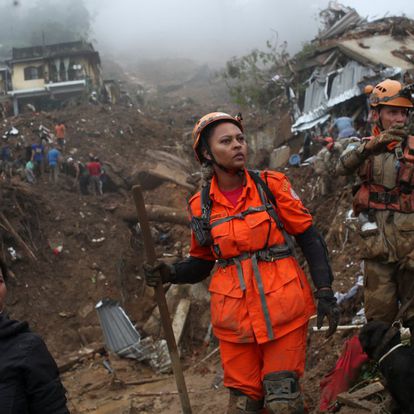 People react as they look for victims at a mudslide at Morro da Oficina after pouring rains in Petropolis, Brazil February 16, 2022.