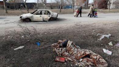 Un cadáver cubierto por una manta en una calle de Mariupol, este domingo.