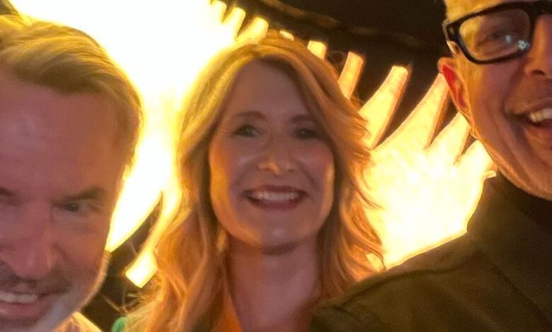 Sam Neill, Laura Dern y Jeff Goldblum se reúnen frente al enorme logotipo de Jurassic Park