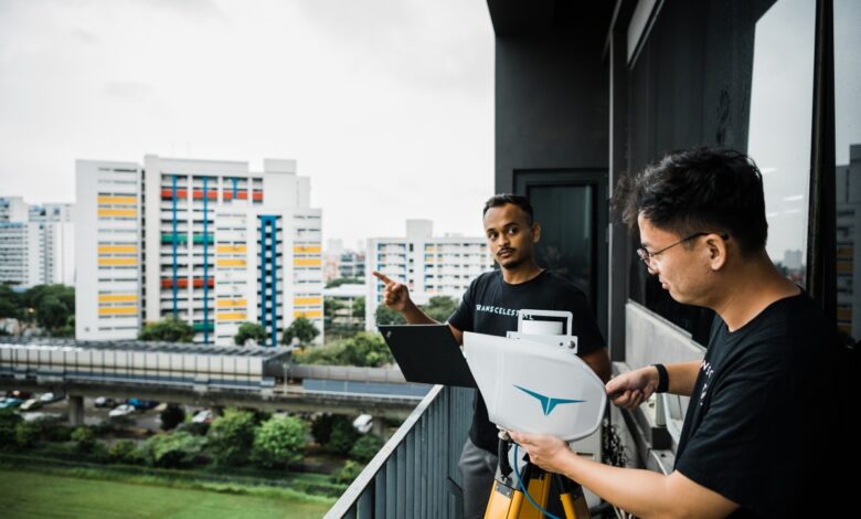 Transcelestial team members installing CENTAURI device on a building