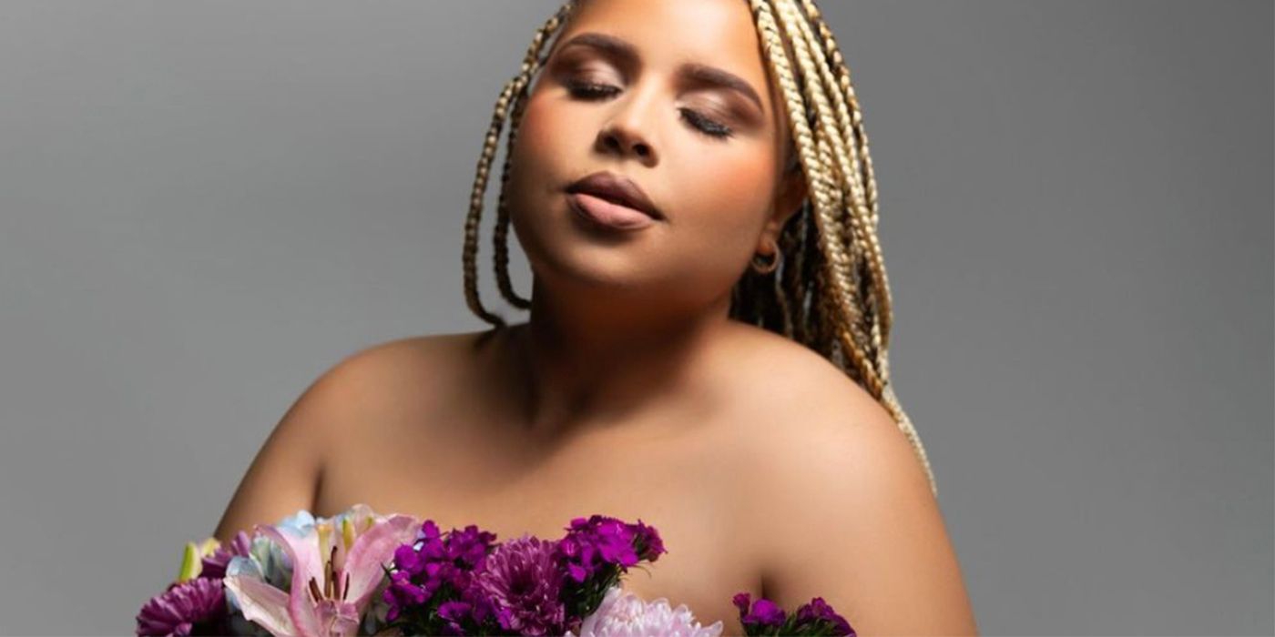 Winter Everett from The Family Chantel posing with flowers eyes closed