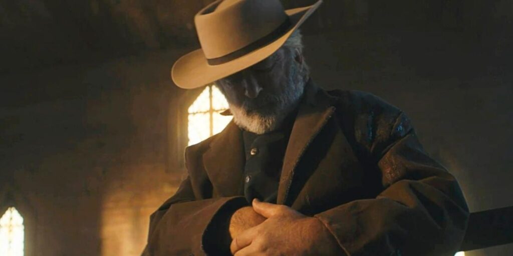 Alec Baldwin's character reaching out for something in his coat in Rust