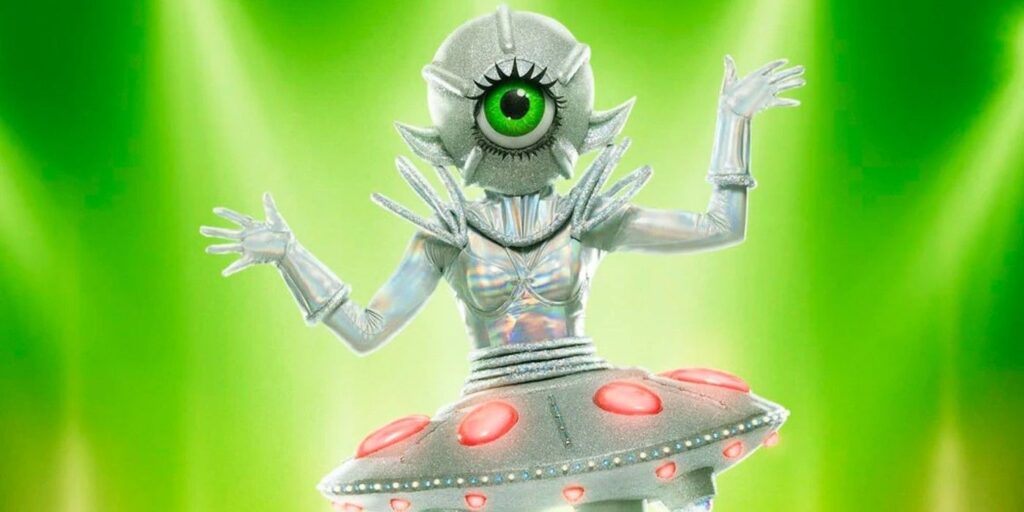 The Masked Singer Season 9 UFO posing against green background