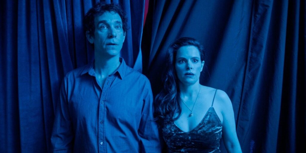 The couple from The End of Sex standing together looking flabbergasted.