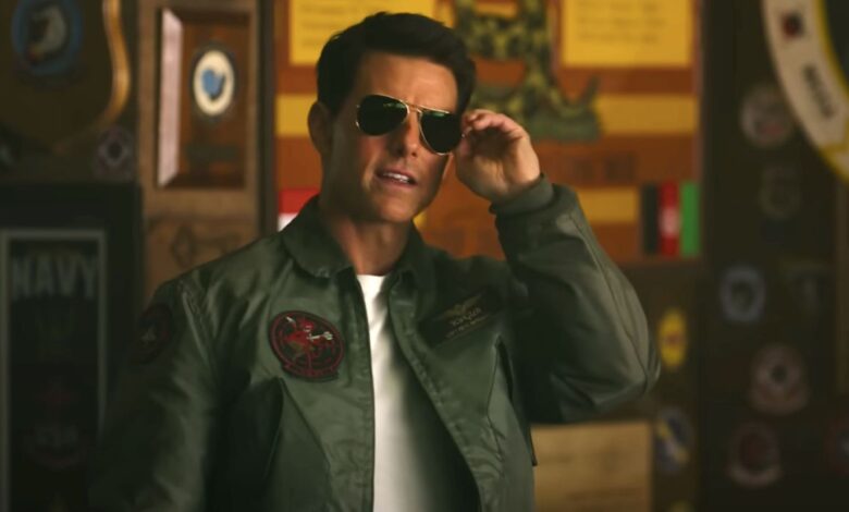 Tom Cruise about to remove his sunglasses in Top Gun: Maverick