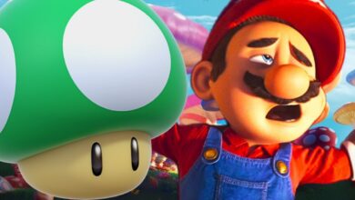 mario is defeated laying next to a green 1-up mushroom