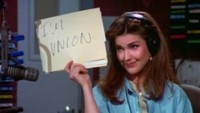 Roz Doyle holds up a sign saying,