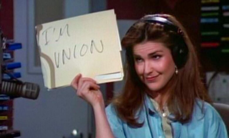 Roz Doyle holds up a sign saying,