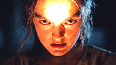 A creepy kid shining a light on their face in the dark in the new Children of the Corn remake
