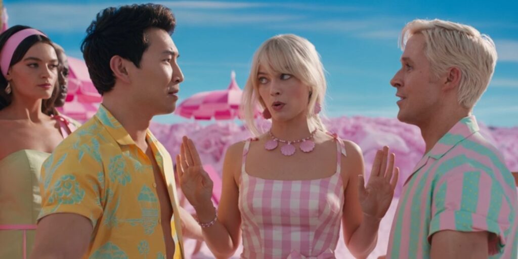 Barbie separating two Kens at the beach