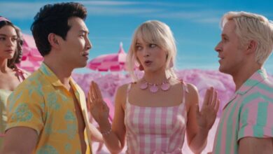 Barbie separating two Kens at the beach