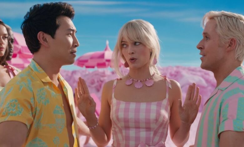 Barbie separating two Kens at the beach