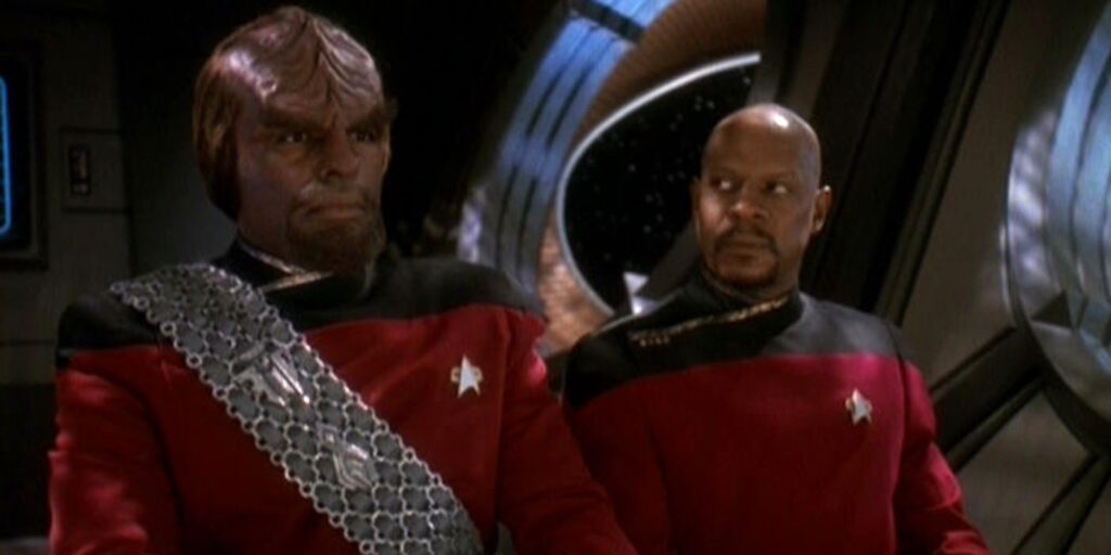 Worf stares off camera while DS9 crew member looks at him questioningly