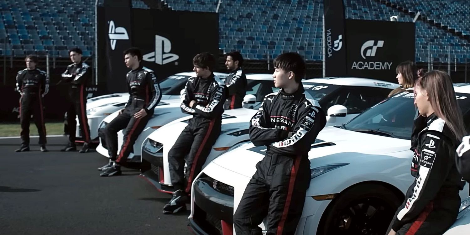 An image of the Gran Turismo cast leaning on all the cars