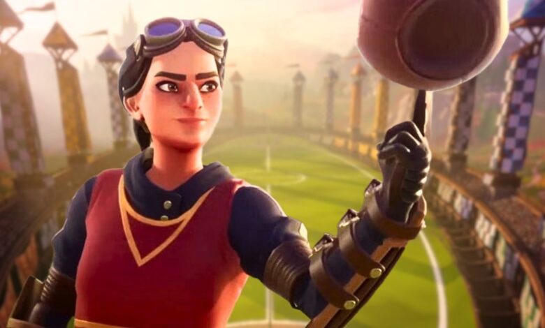 A female Quidditch player wearing a Gryffindor uniform and balancing a Quaffle on her finger with the Quidditch pitch from Harry Potter: Quidditch Champions in the background.