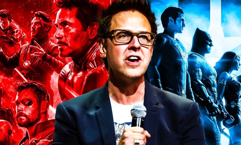 James Gunn in front of art for The Avengers and Justice League