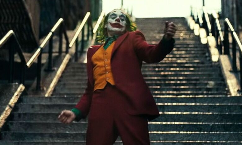 Joaquin Phoenix as Arthur Fleck dancing down stairs in Joker