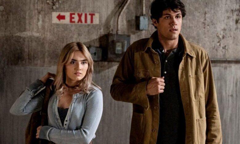 John and Mary carrying their items and looking at something in the Winchesters-1