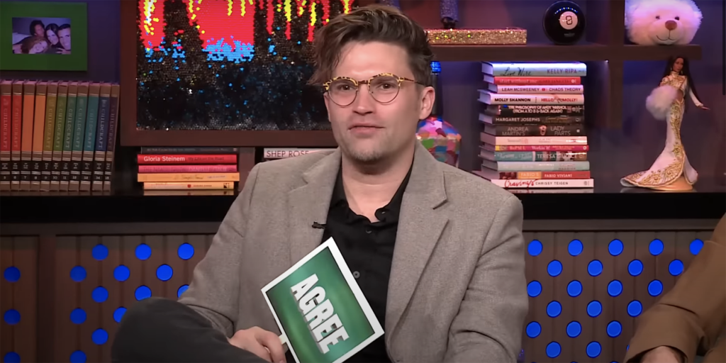 Tom Schwartz from Vanderpump Rules on Watch What Happens Live holding