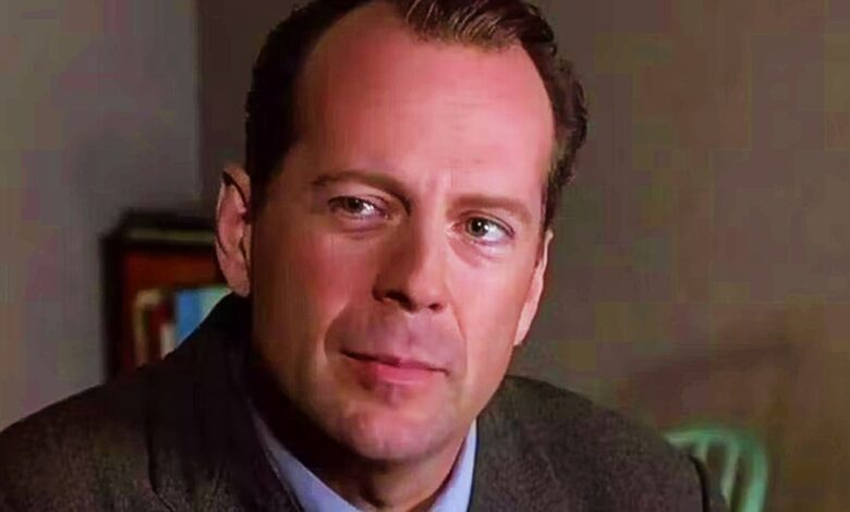Bruce Willis as Malcolm smiling slightly in The Sixth Sense