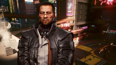 Cyberpunk 2077's Goro Takemura in front of a Night City intersection where the game's Overdrive Mode is used to showcase path traced lighting.