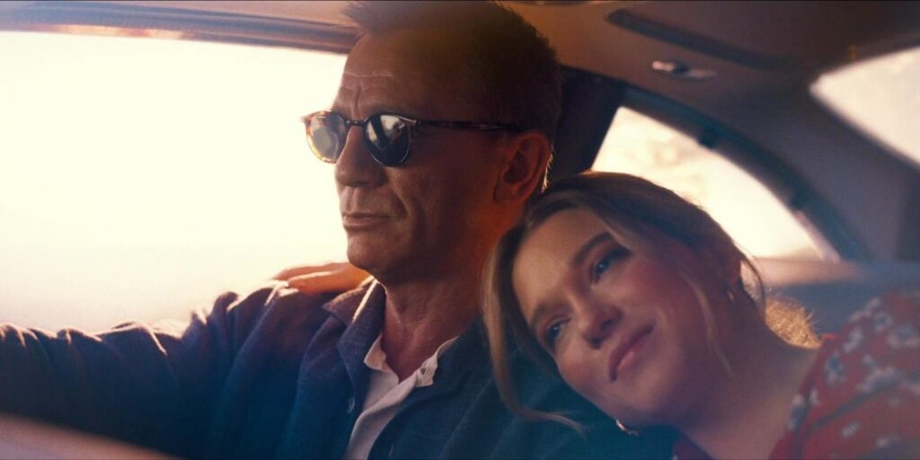 James Bond driving with Madeleine in his arms in No Time to Die