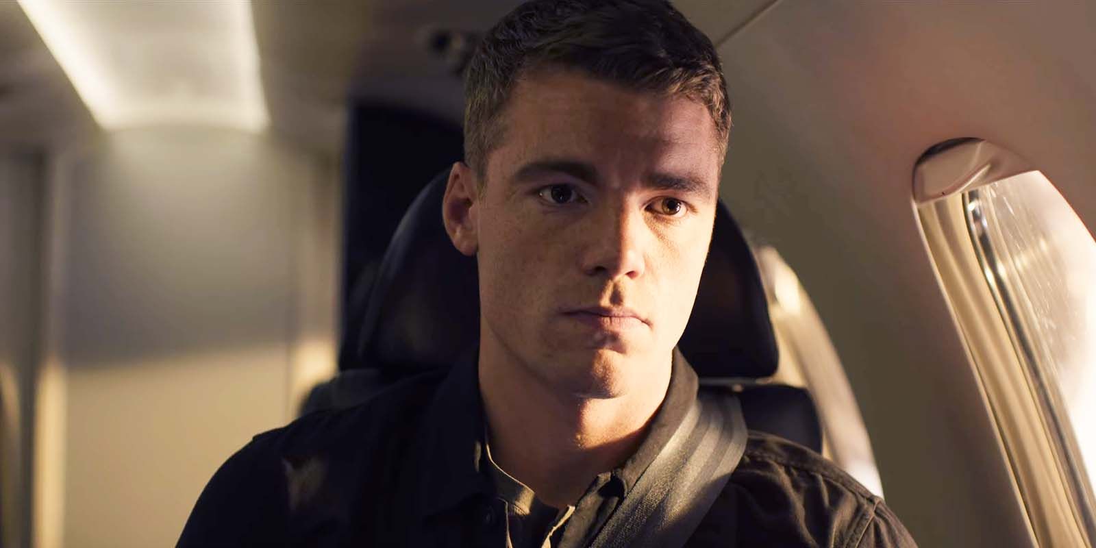 Gabriel Basso as Peter Sutherland sitting in a jet in The Night Agent season 1