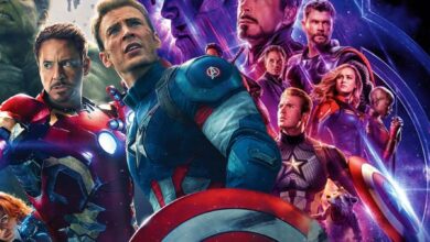 The team from Avengers: Age of Ultron next to the poster for Avengers Endgame