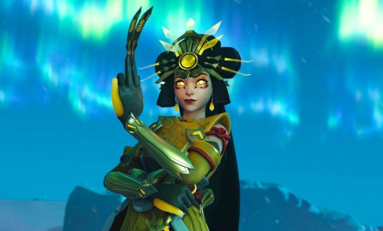 Overwatch 2 Kiriko wearing her mythic skin and holding up her healing ofuda on the Antarctic Peninsula map.