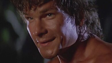 Patrick Swayze in Road House in the middle of a fight, smiling
