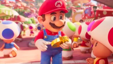 Mario holding a gold coin in The Super Mario Bros. Movie.