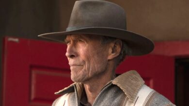 Clint Eastwood in Cry Macho wearing a cowboy hat and gazing pensively into the distance