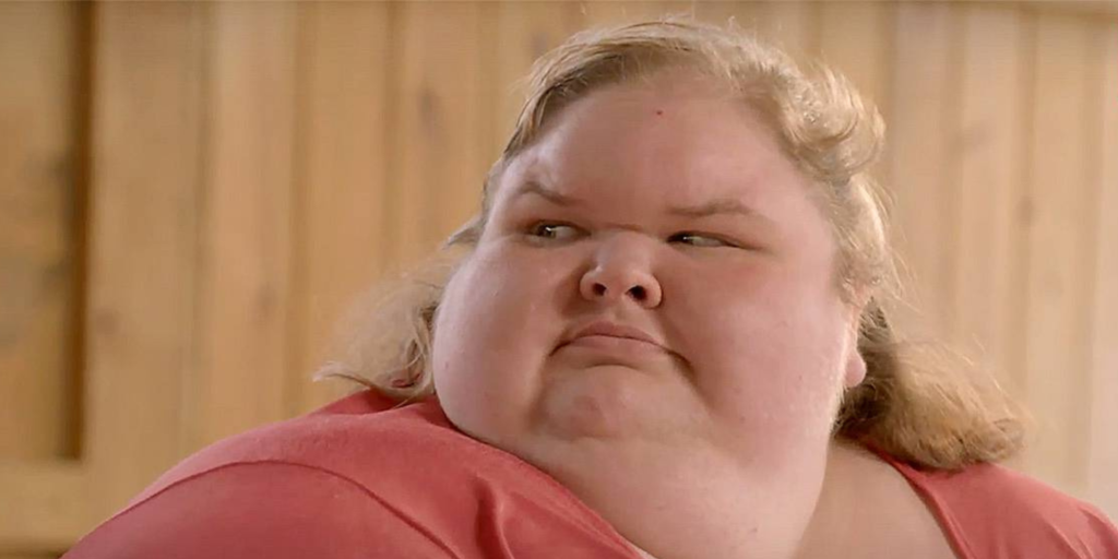 Tammy Slaton from 1000-Lb Sisters wearing orange shirt looking to the side