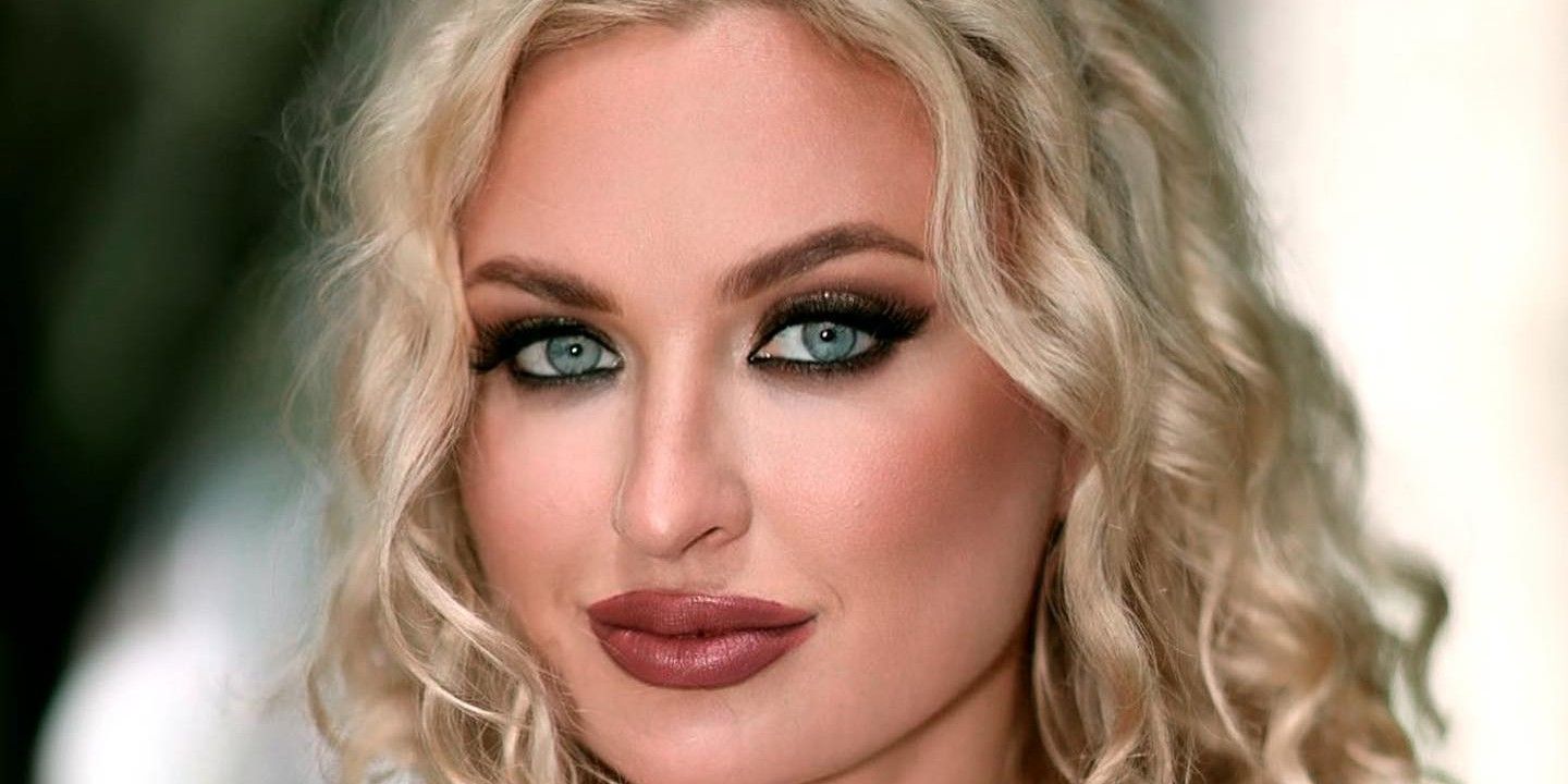 Natalie Mordovtseva from 90 Day Fiance wearing glam makeup smirking