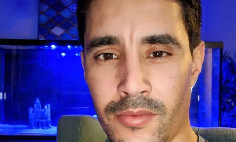 Mohamed Jbali from 90 Day Fiancé posing against blue background
