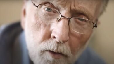 Tobin Bell in The Curse of Wolf Mountain wearing glasses looking intently into the camera