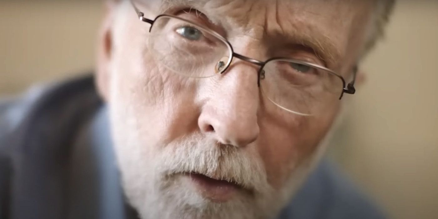 Tobin Bell in The Curse of Wolf Mountain wearing glasses looking intently into the camera