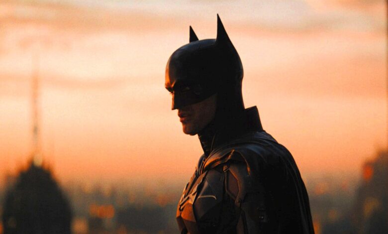 Robert Pattinson as Batman in The Batman looking over Gotham