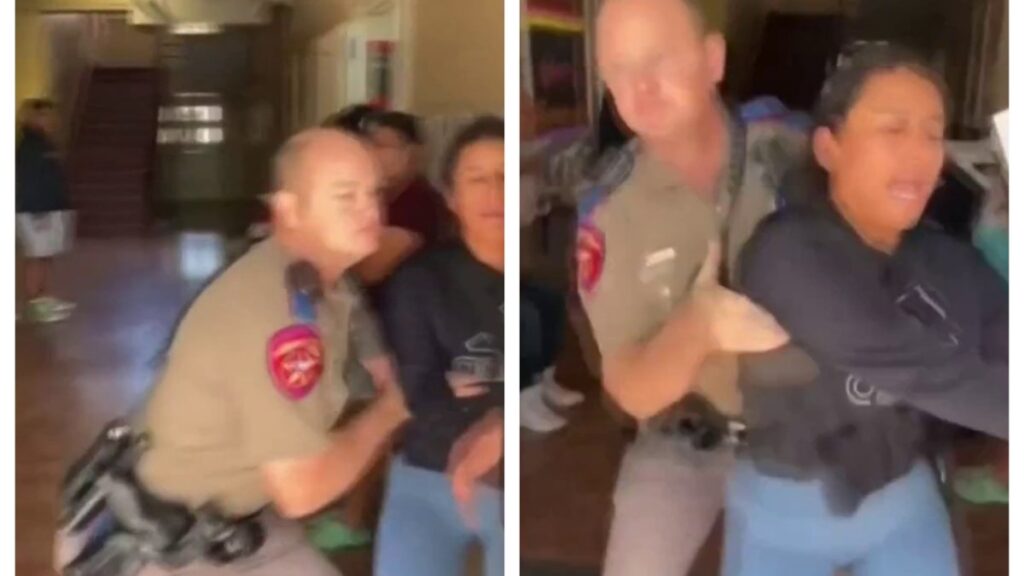 captan oficial de DPS forcejando con madre