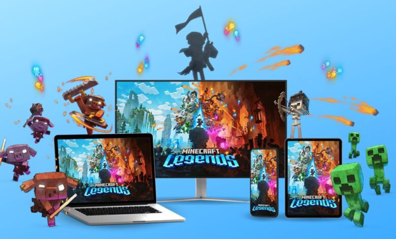Minecraft Legends Image showing a computer, tv, table, and phone all with the Minecraft Legends loading screen, with creepers, piglins, and other Minecraft characters charging around them