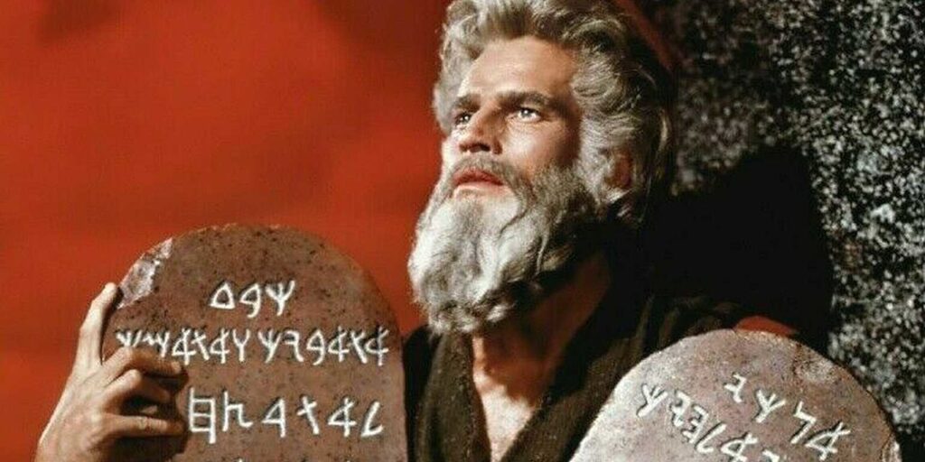 Charlton Heston as Moses holding the ten commandments in The Ten Commandments